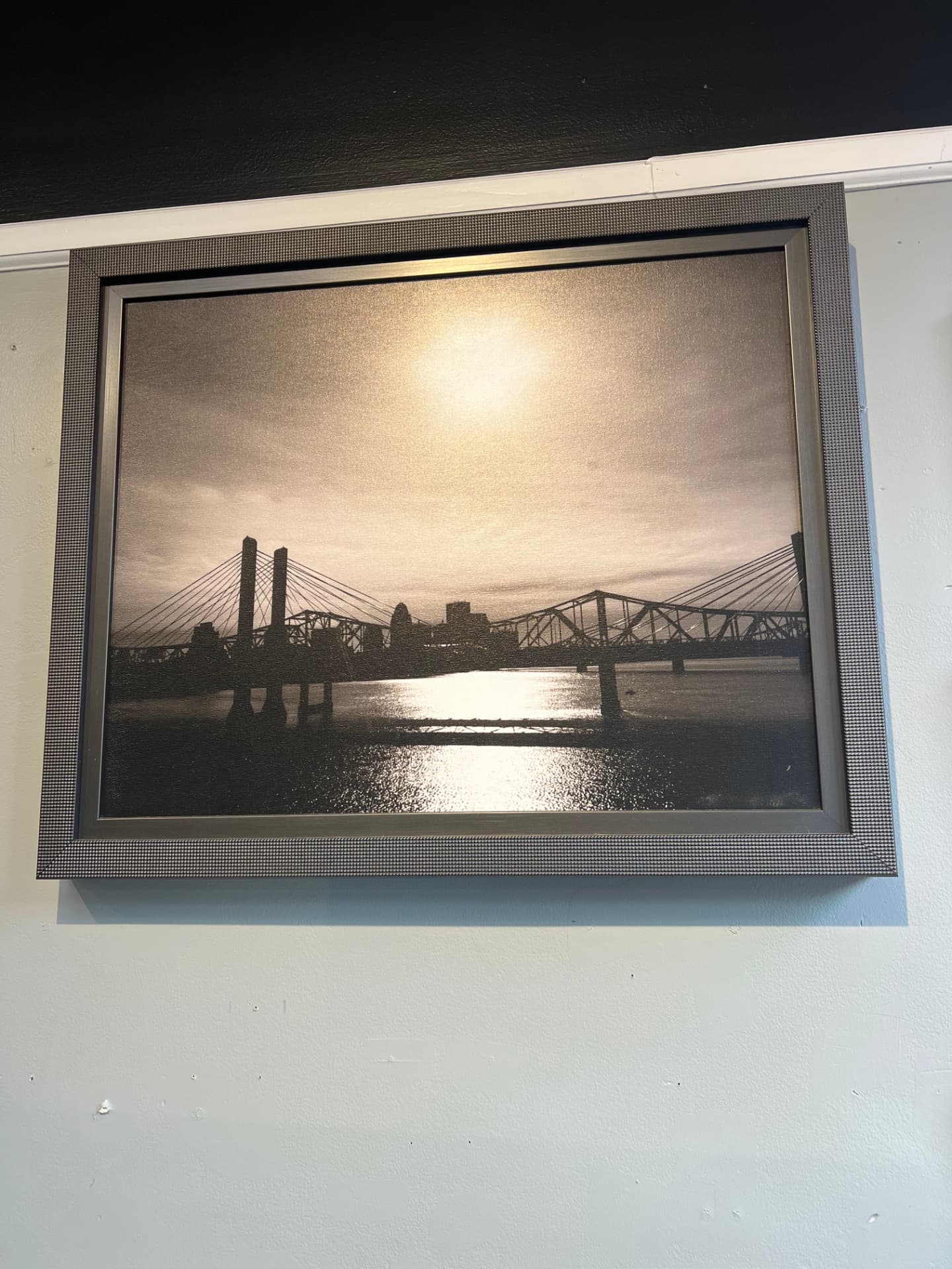 Sepia photograph of the Louisville skyline and Ohio River bridges in a textured pewter frame
